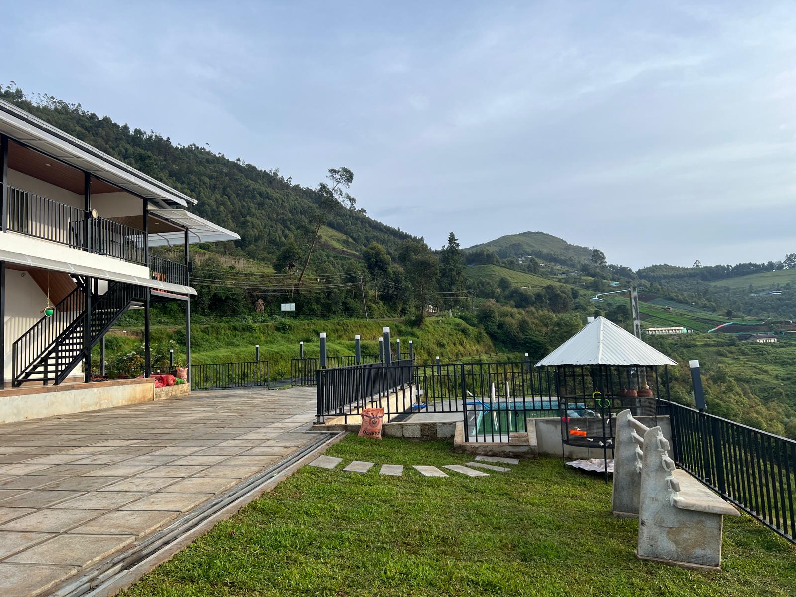 Vattavada Valley misty mountains and farm resort view